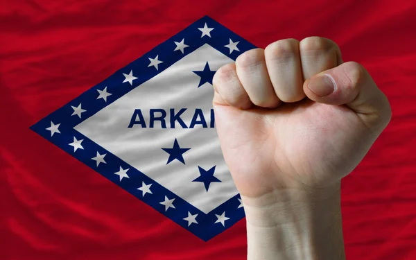 Us state flag of arkansas with hard fist in front of it symboliz — Stock Photo, Image