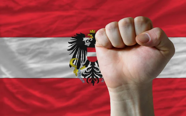 Hard fist in front of austria flag symbolizing power — Stock Photo, Image