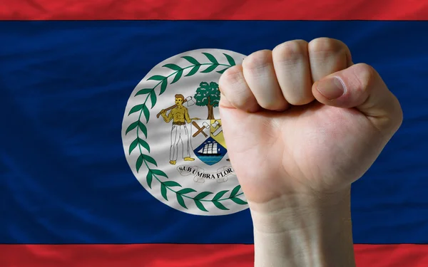 Punho duro na frente da bandeira do Belize simbolizando o poder — Fotografia de Stock