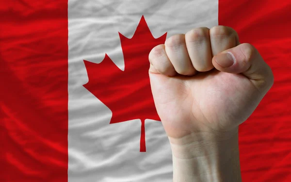 Punho duro na frente da bandeira do Canadá simbolizando o poder — Fotografia de Stock