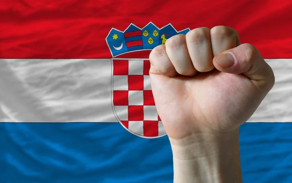 Hard fist in front of croatia flag symbolizing power — Stock Photo, Image
