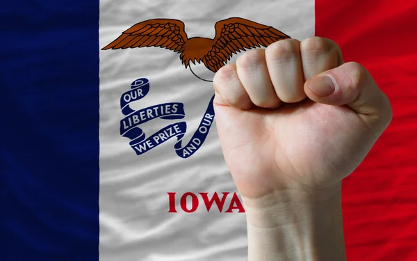 Us state flag of iowa with hard fist in front of it symbolizing — Stock Photo, Image