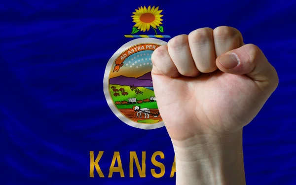 Us state flag of kansas with hard fist in front of it symbolizin — Stock Photo, Image