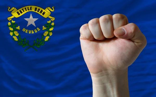 Us state flag of nevada with hard fist in front of it symbolizin — Stock Photo, Image