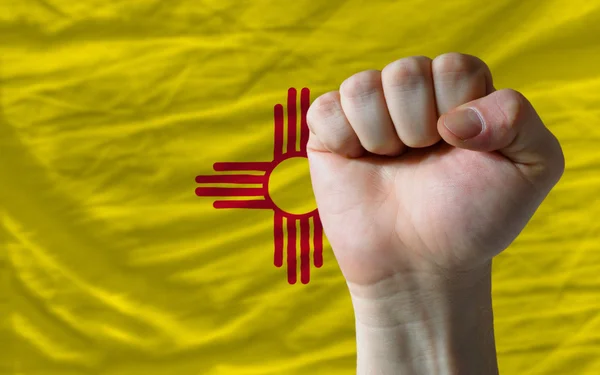 Us state flag of new mexico with hard fist in front of it symbol — Stock Photo, Image