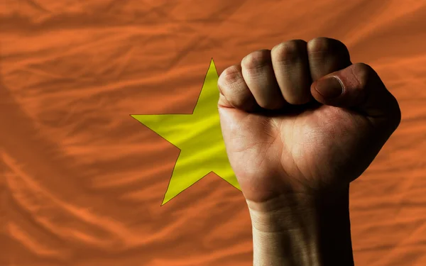 Hard fist in front of vietnam flag symbolizing power — Stock Photo, Image