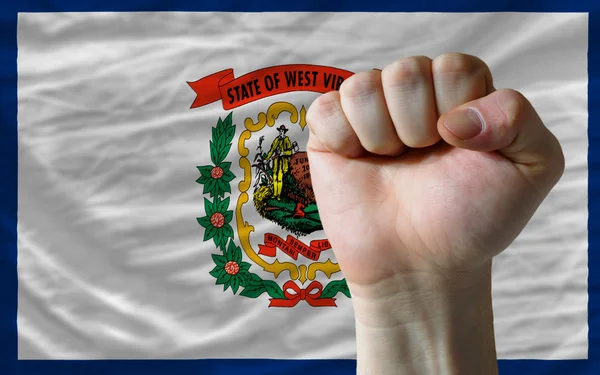 Us state flag of west virginia with hard fist in front of it sym — Stock Photo, Image