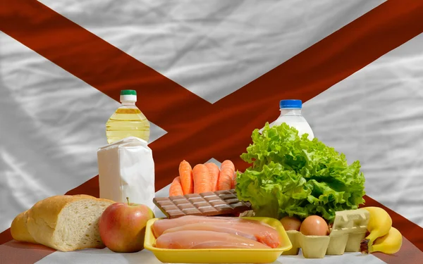 Basic food groceries in front of alabama us state flag — Stock Photo, Image