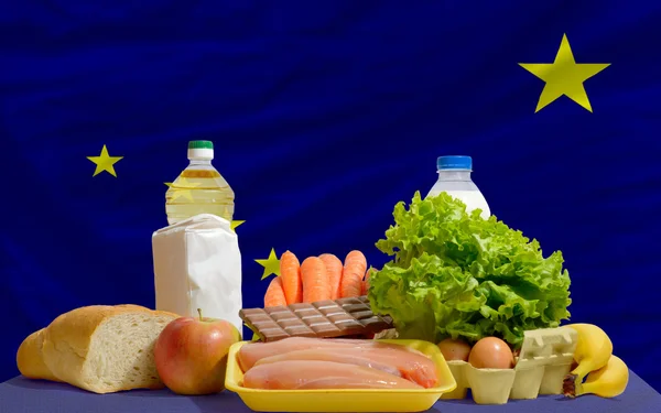 Basic food groceries in front of alaska us state flag — Stock Photo, Image