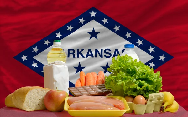 Basic food groceries in front of arkansas us state flag — Stock Photo, Image