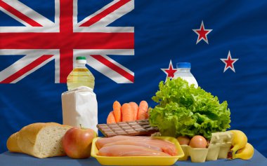 Basic food groceries in front of new zealand national flag