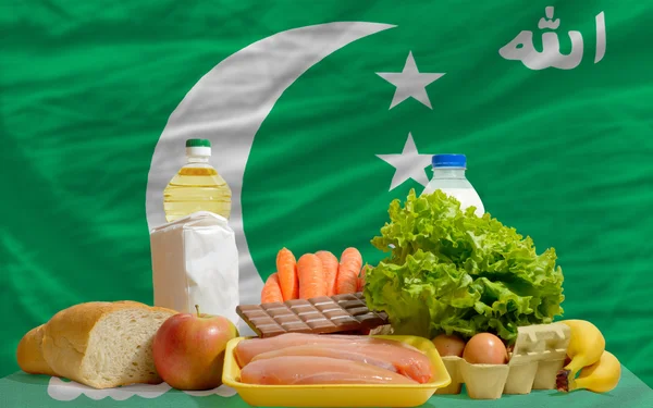 stock image Basic food groceries in front of comoros national flag