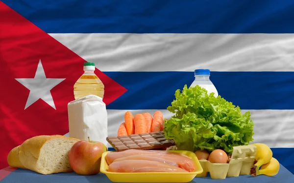 Basic food groceries in front of cuba national flag — Stockfoto