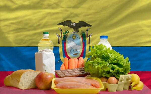 stock image Basic food groceries in front of ecuador national flag