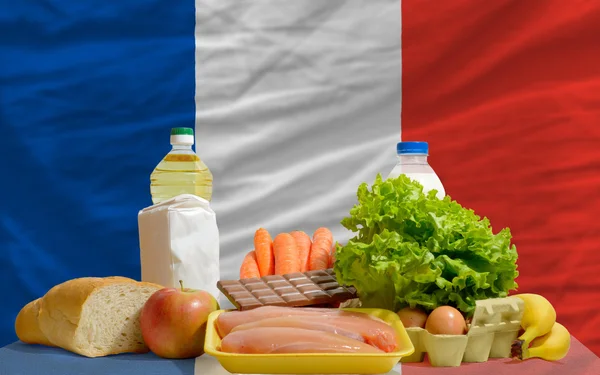 Basic food groceries in front of france national flag — Stock Photo, Image