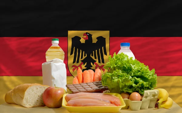 Basic food groceries in front of germany national flag — Zdjęcie stockowe