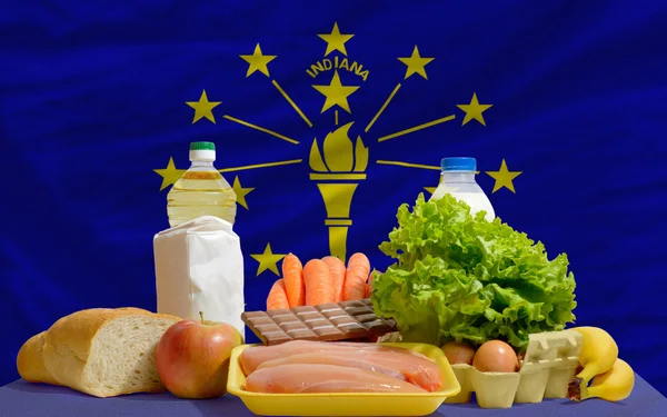 Basic food groceries in front of indiana us state flag — Stock Photo, Image