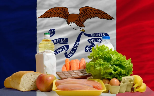 Basic food groceries in front of iowa us state flag — Stock Photo, Image