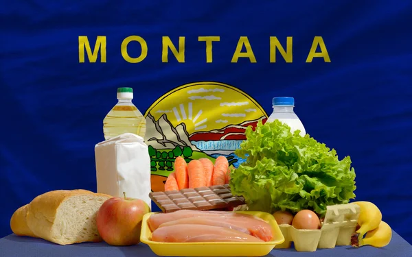 Basic food groceries in front of montana us state flag — Stock Photo, Image