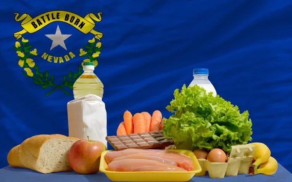 Basic food groceries in front of nevada us state flag — Stock Photo, Image