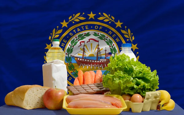 Basic food groceries in front of new hampshire us state flag — Stock Photo, Image