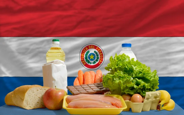 stock image Basic food groceries in front of paraguay national flag