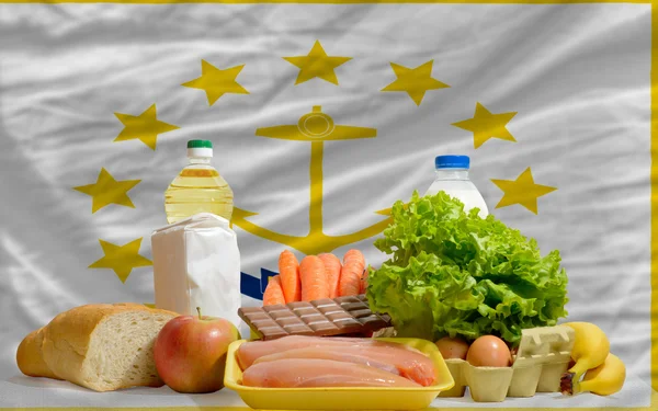 Basic food groceries in front of rhode island us state flag — Stock Photo, Image