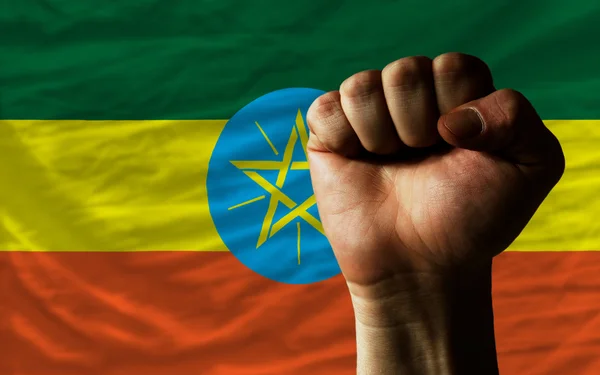 Hard fist in front of ethiopia flag symbolizing power — Stock Photo, Image