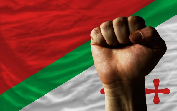 Hard fist in front of katanga flag symbolizing power — Stock Photo, Image