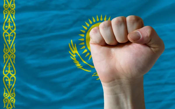 Hard fist in front of kazakhstan flag symbolizing power — Stock Photo, Image
