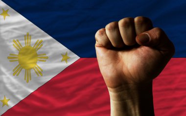 Hard fist in front of philippines flag symbolizing power clipart