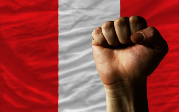 Hard fist in front of peru flag symbolizing power — Stock Photo, Image