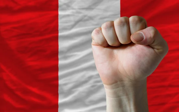Hard fist in front of peru flag symbolizing power — Stock Photo, Image