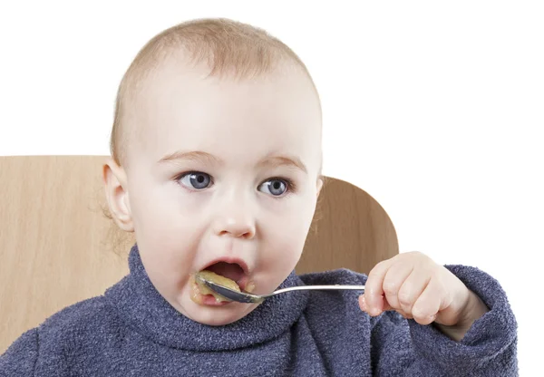 Baby isst Apfelmus — Stockfoto