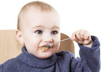 Baby eating applesauce clipart