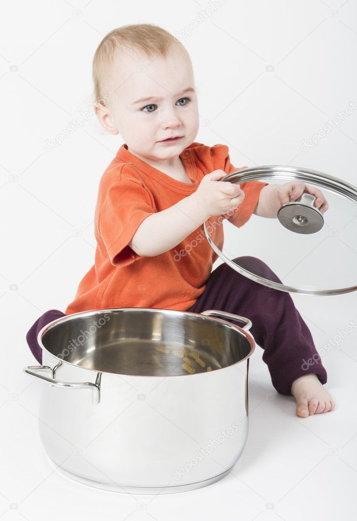 Baby with big cooking pot — Stock Photo © gewoldi 11750492