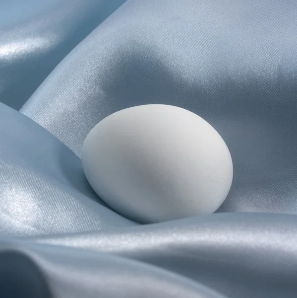 Stock image Egg in blue satin