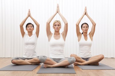 Interracial Group of Three Beautiful Women In Yoga Position clipart