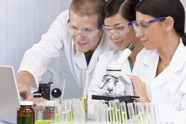Interracial tým vědců v laboratoři s notebookem — Stock fotografie