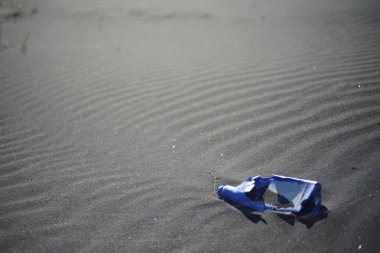 Degenerating water container by the beach clipart