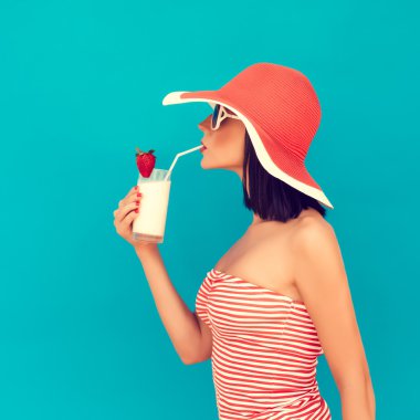 Sensual woman with sunglasses drinking a cocktail clipart