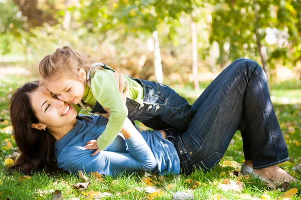 Frau mit Kind vergnügt sich im Herbstpark — Stockfoto