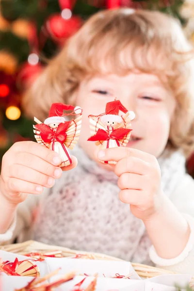 Happy child holding decorations — Stock Photo, Image
