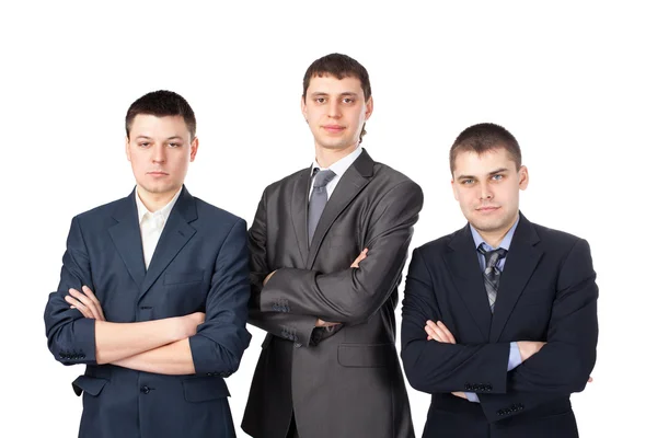Três jovens homens de negócios de pé com as mãos dobradas isolados em — Fotografia de Stock