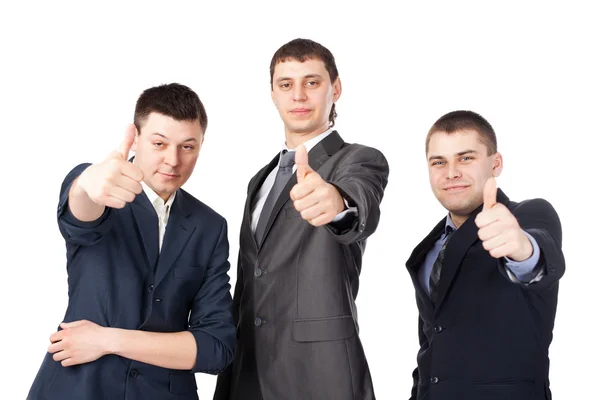 Tre unga affärsmän skrattar och ger tummen upp skylt — Stockfoto