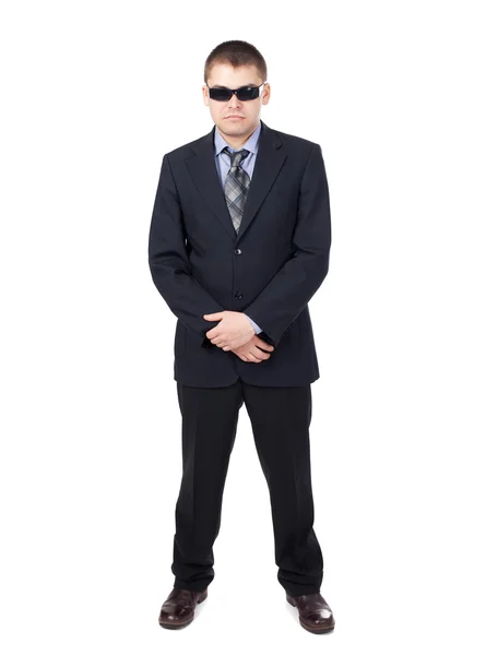 Guardia di sicurezza indossa un abito e occhiali da sole isolati su b bianco — Foto Stock