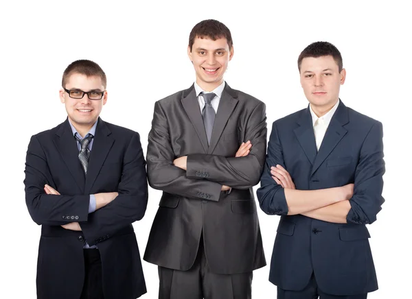 Három fiatal, mosolygós üzletemberek isol összekulcsolt kézzel állva — Stock Fotó