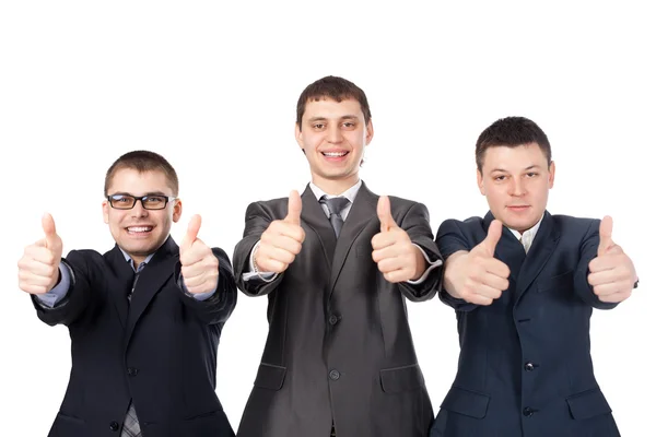 Tre giovani uomini d'affari ridendo e dando il pollice su segno — Foto Stock