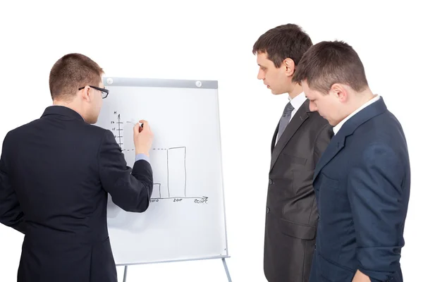 Three young business men and a flipchart isolated on white back — Stock Photo, Image