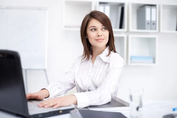 Portrait of beautiful young smiling business woman working on a Royalty Free Stock Images